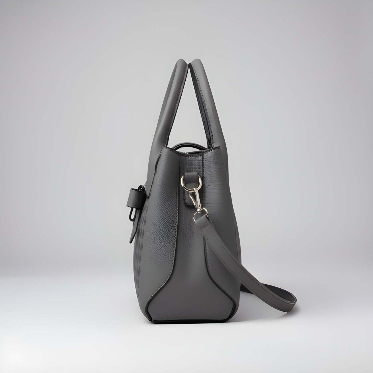 Gray handbag with a shoulder strap on a light gray background