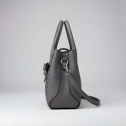Gray handbag with a shoulder strap on a light gray background