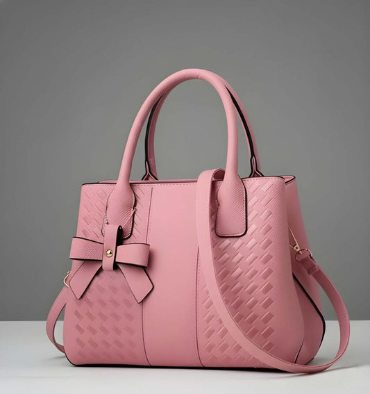 Pink handbag with a bow detail on a gray background