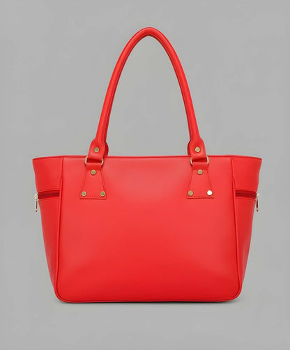Red handbag with gold accents on a gray background
