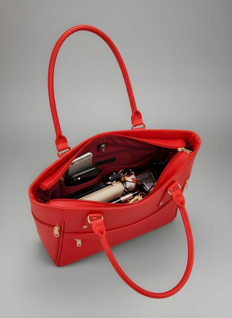 Red handbag with gold accents on a gray background