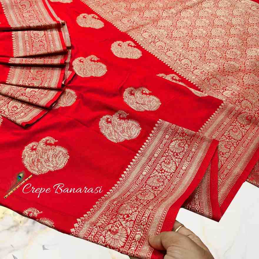 Red saree with gold patterns and 'Crepe Banarasi' text on a white background
