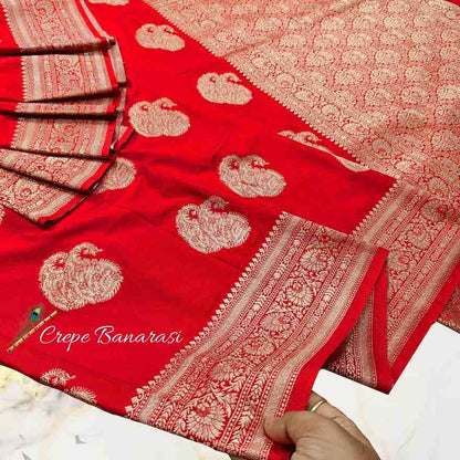Red saree with gold patterns and 'Crepe Banarasi' text on a white background