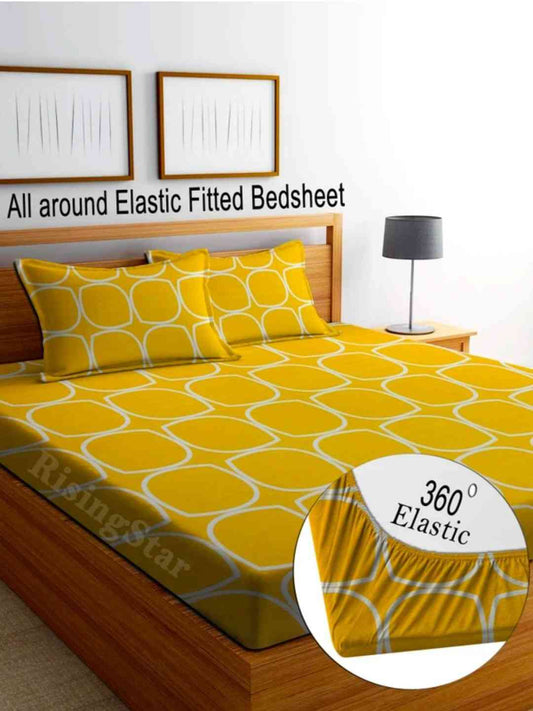 Yellow patterned fitted bedsheet on a bed with '360° Elastic' feature highlighted.