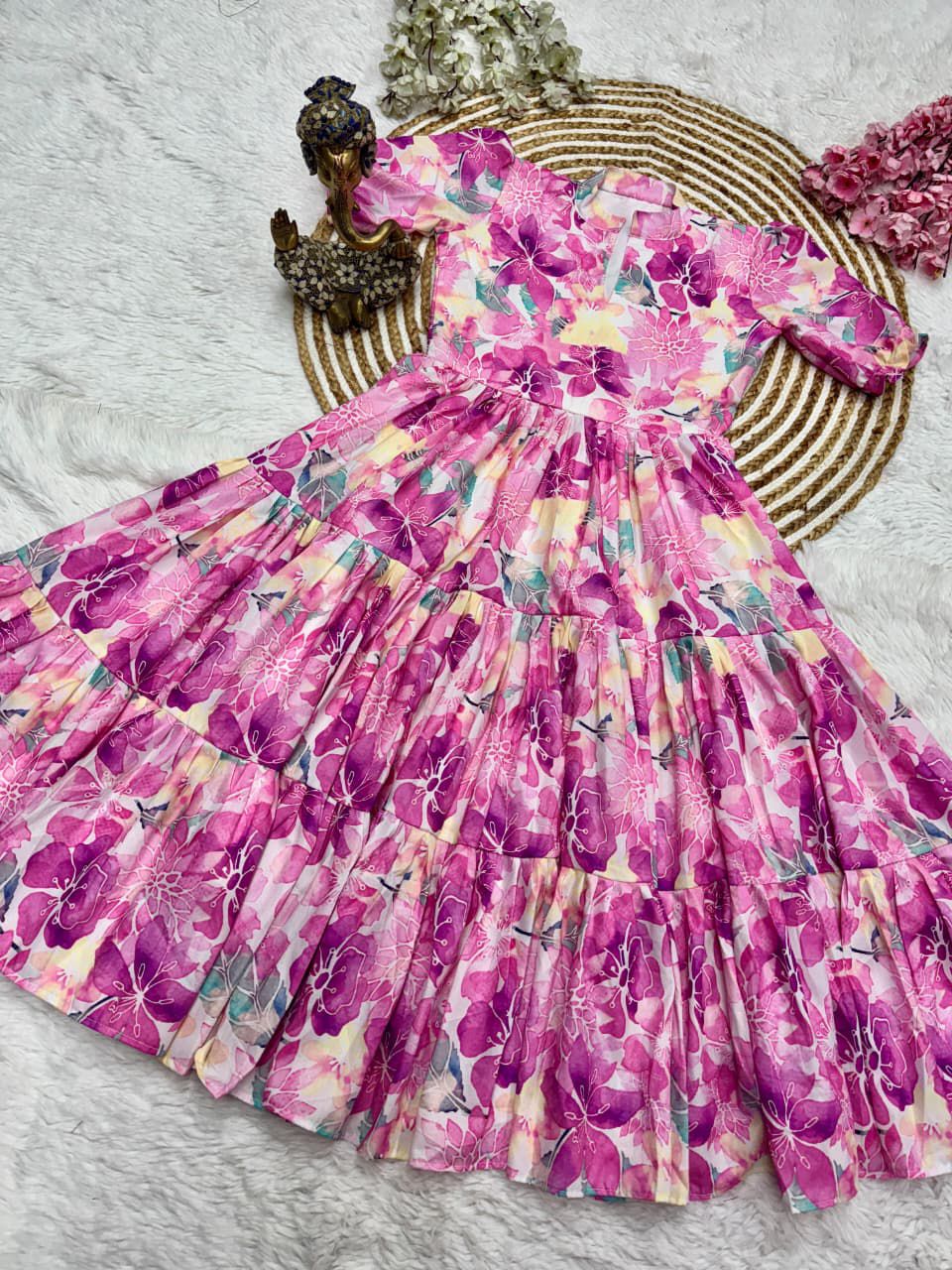 Pink floral dress on a textured surface with decorative elements.