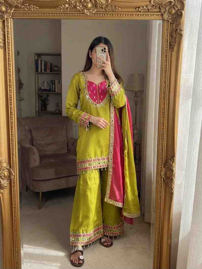 “Flat lay ethnic kurti palazzo dupatta set with embroidery and traditional design”