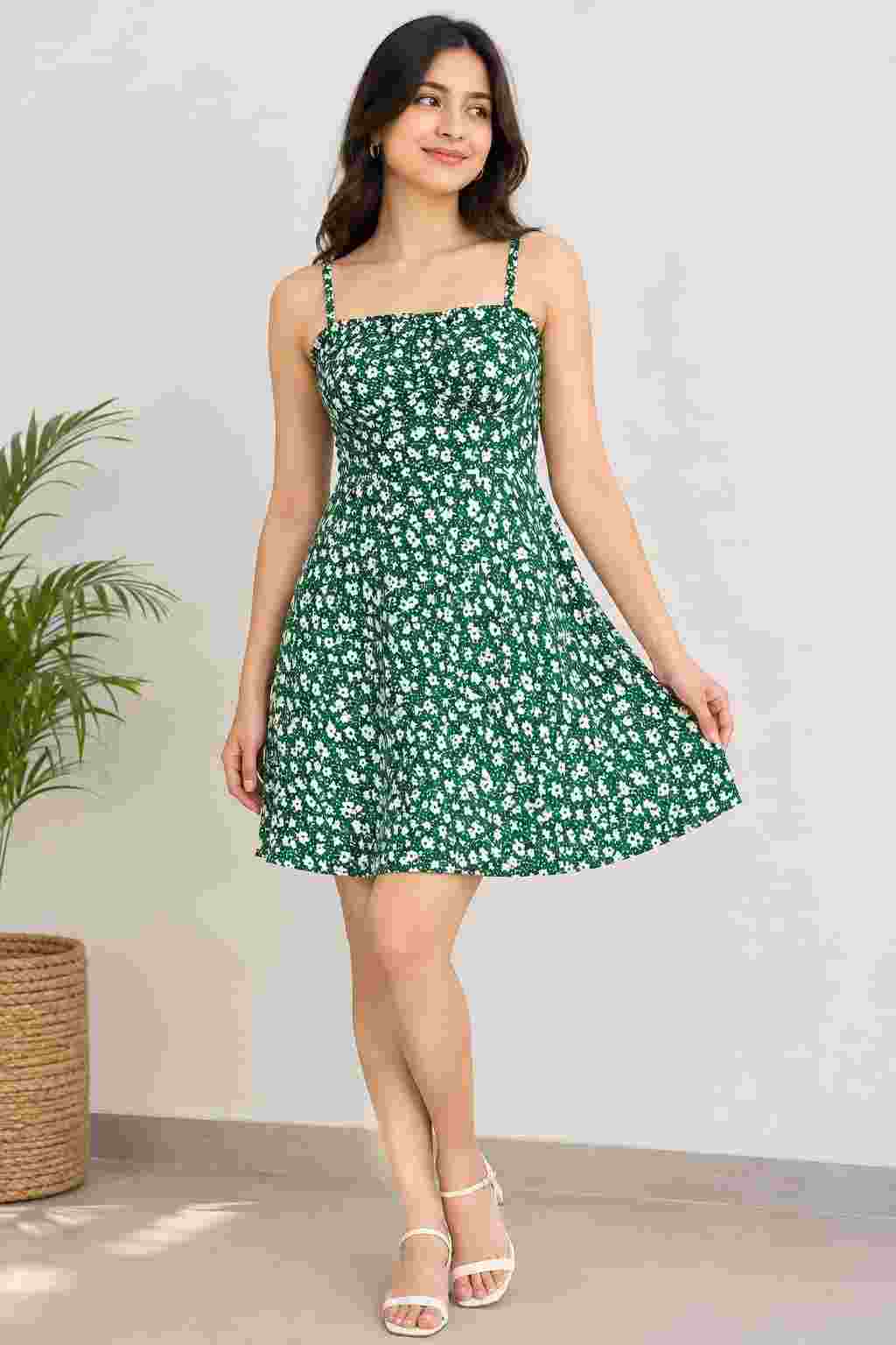 Standing view wearing a floral printed A-line dress.   