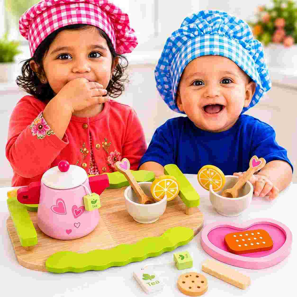 Wooden tea party set for toddlers with toy teapot, teacups, saucers, tray and pretend play snacks.