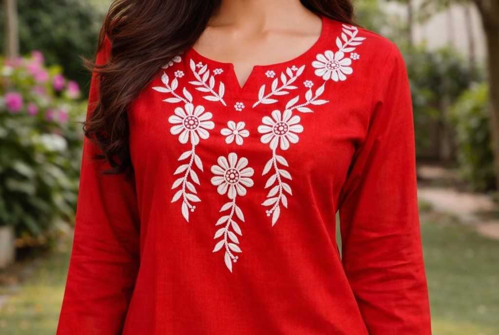 Red top with white floral embroidery worn by a person outdoors.
