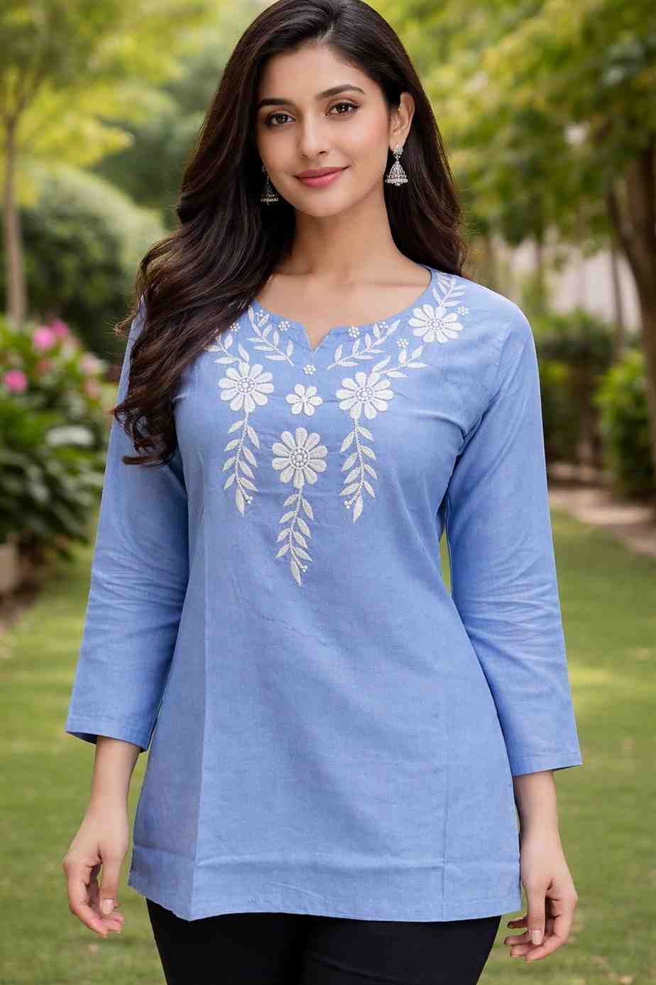 Woman wearing a blue embroidered top outdoors