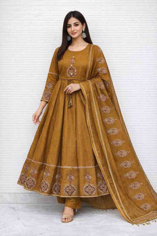 Mustard Anarkali kurta set with ethnic prints, matching dupatta and pants, featuring a flowy design and traditional detailing, styled for festive and casual wear.
